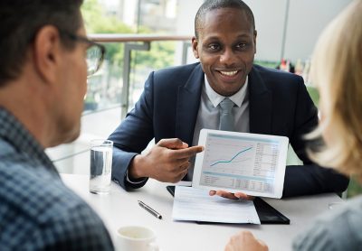 financial advisor showing data to couple