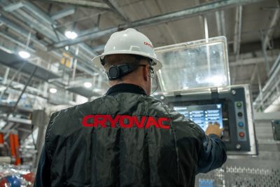 two service technicians performing maintenance on cryovac equipment
