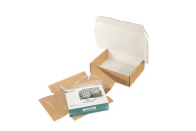 blood pressure monitor next to packaging materials and a cardboard box