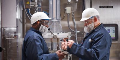 two men in a warehouse shaking hands 